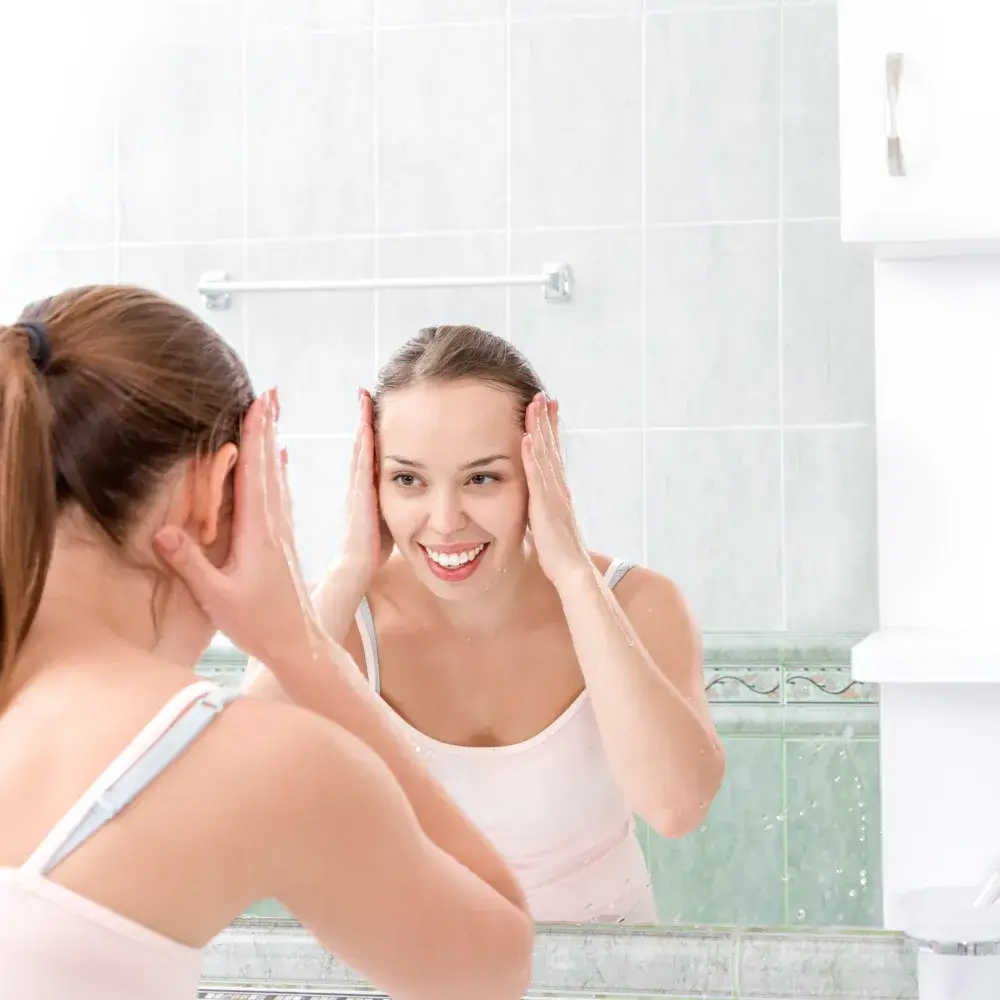 woman smiling in front of the mirror of a bathroom