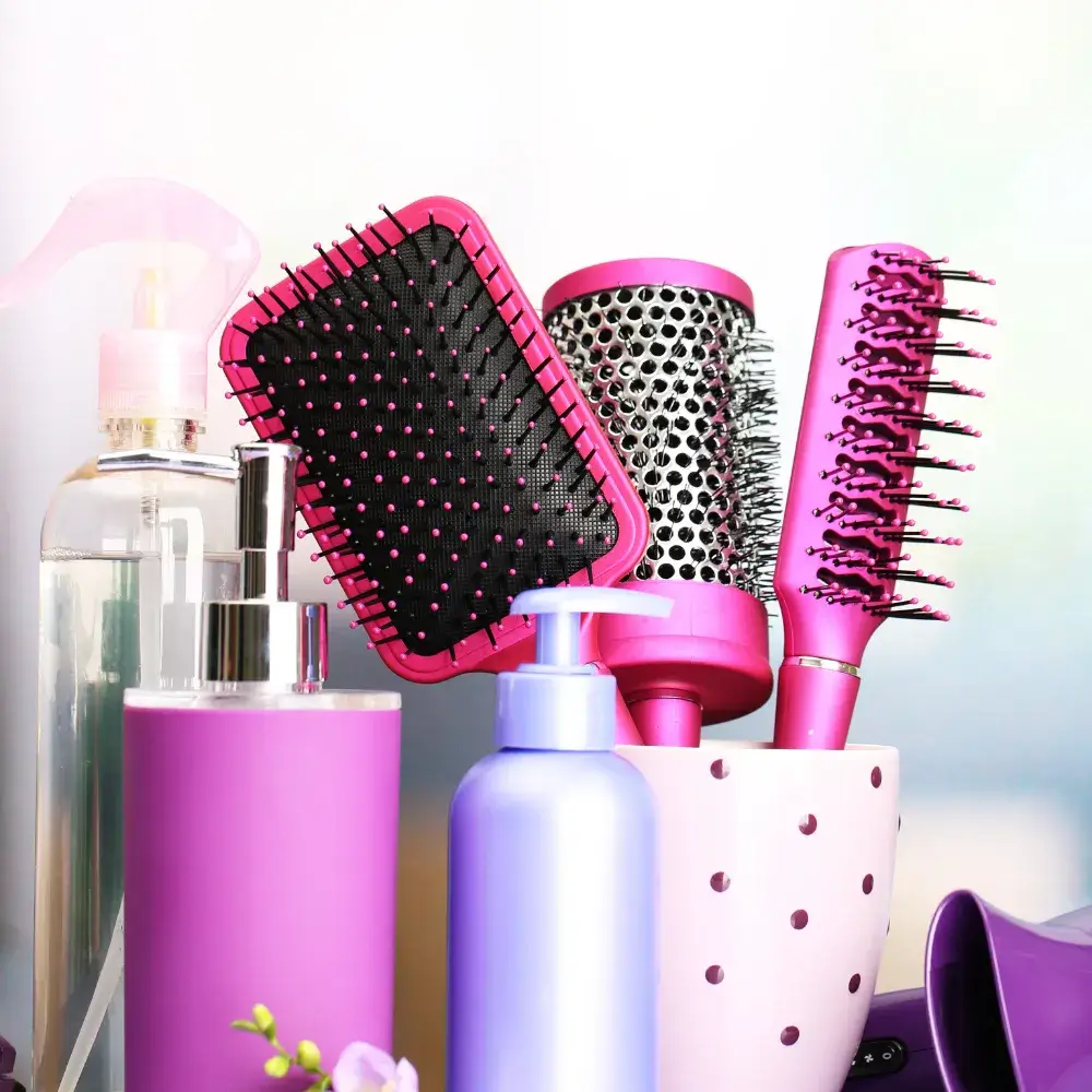 pink hair brushes and cosmetic bottles