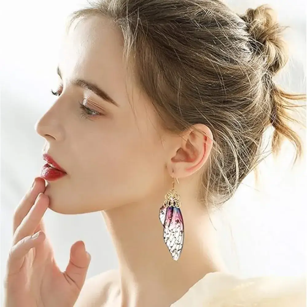 close-up side view of a beautiful woman wearing pink butterfly wings earrings