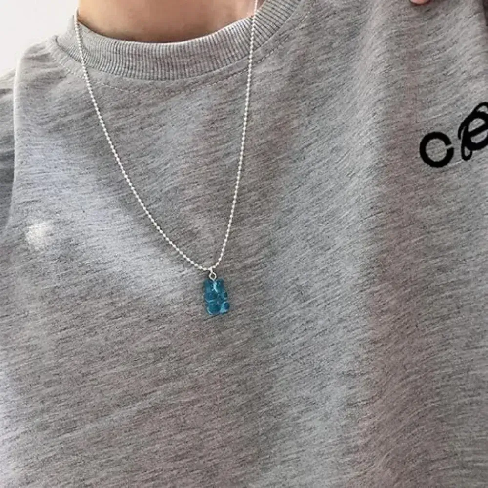 close-up of a blue gummy bear necklace