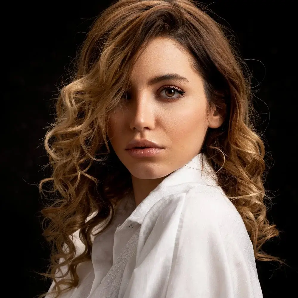 What is the best way to apply a hair-lightening spray for even results?