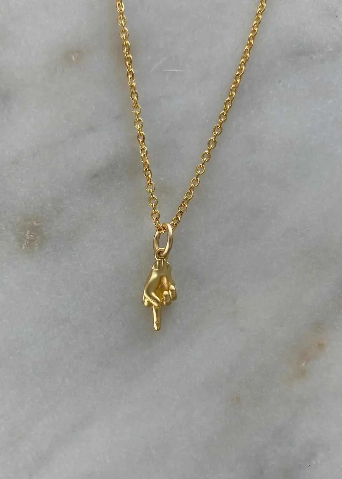 How should I Clean a middle finger Necklace?
