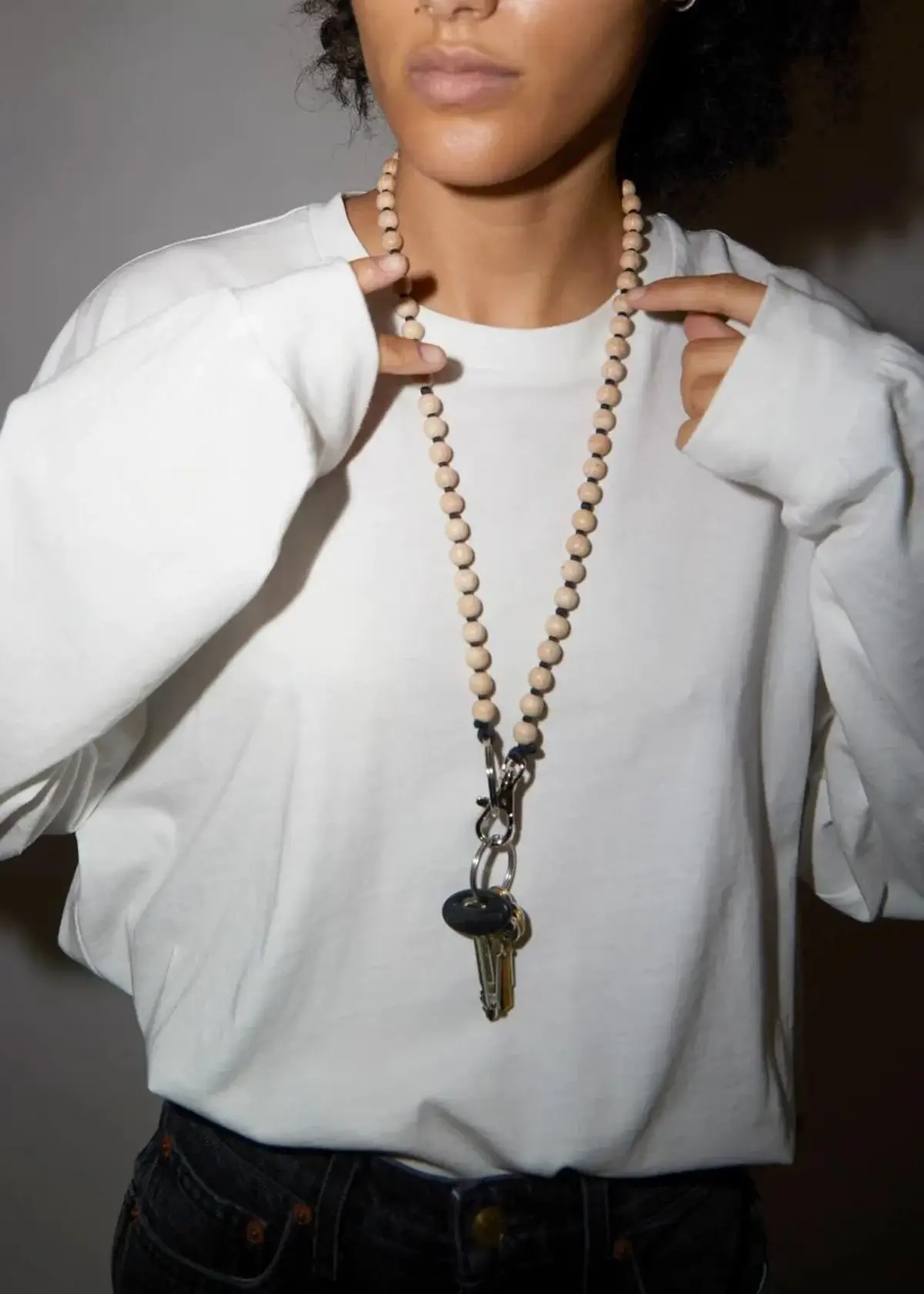 How do I attach my keys to a key holder necklace?