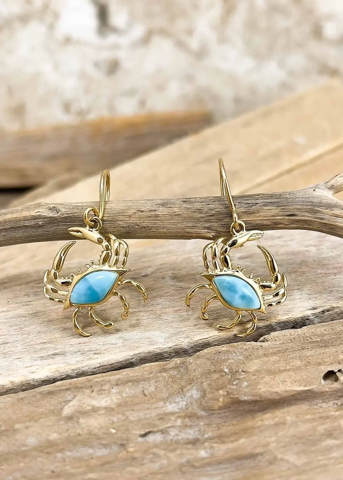 What materials are commonly used to make crab earrings?