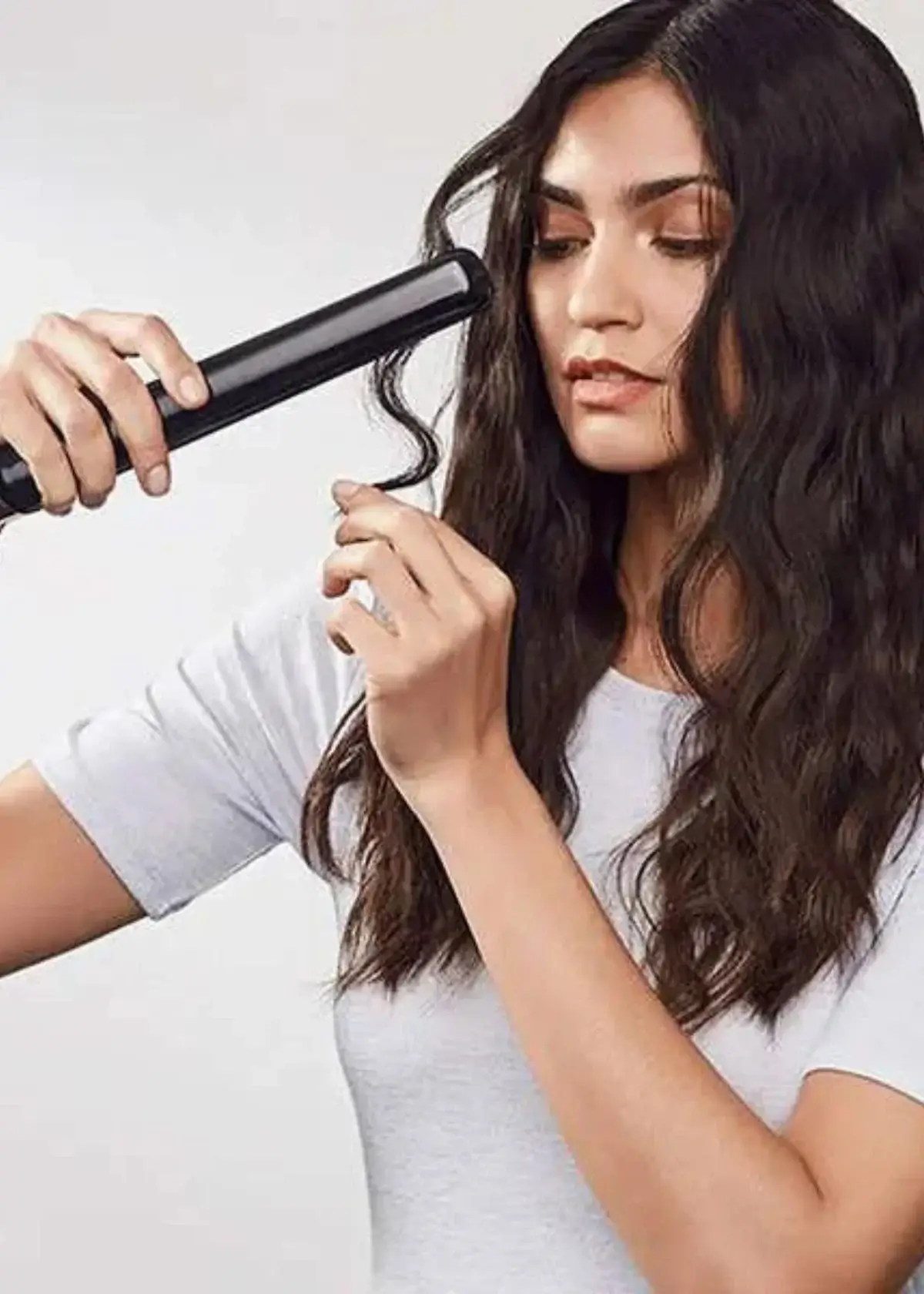 How do I protect my curly hair from heat damage when using a straightener?