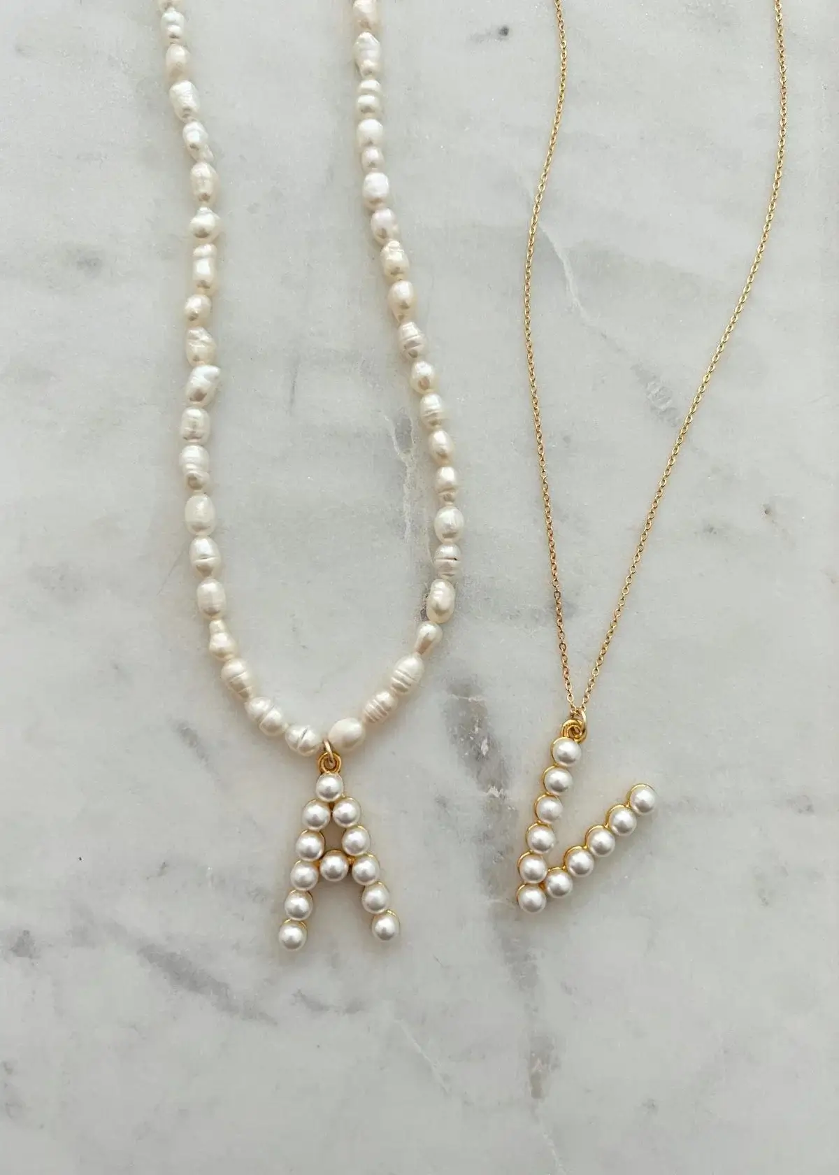 What materials are commonly used in pearl initial necklaces?