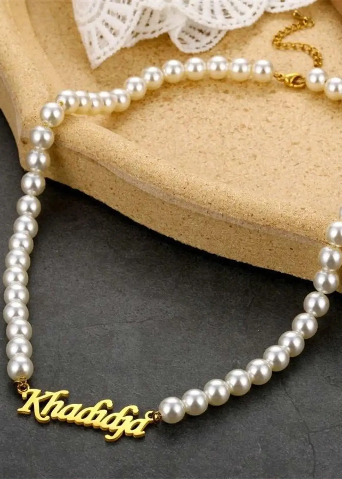 What metals are used in a pearl name necklace?