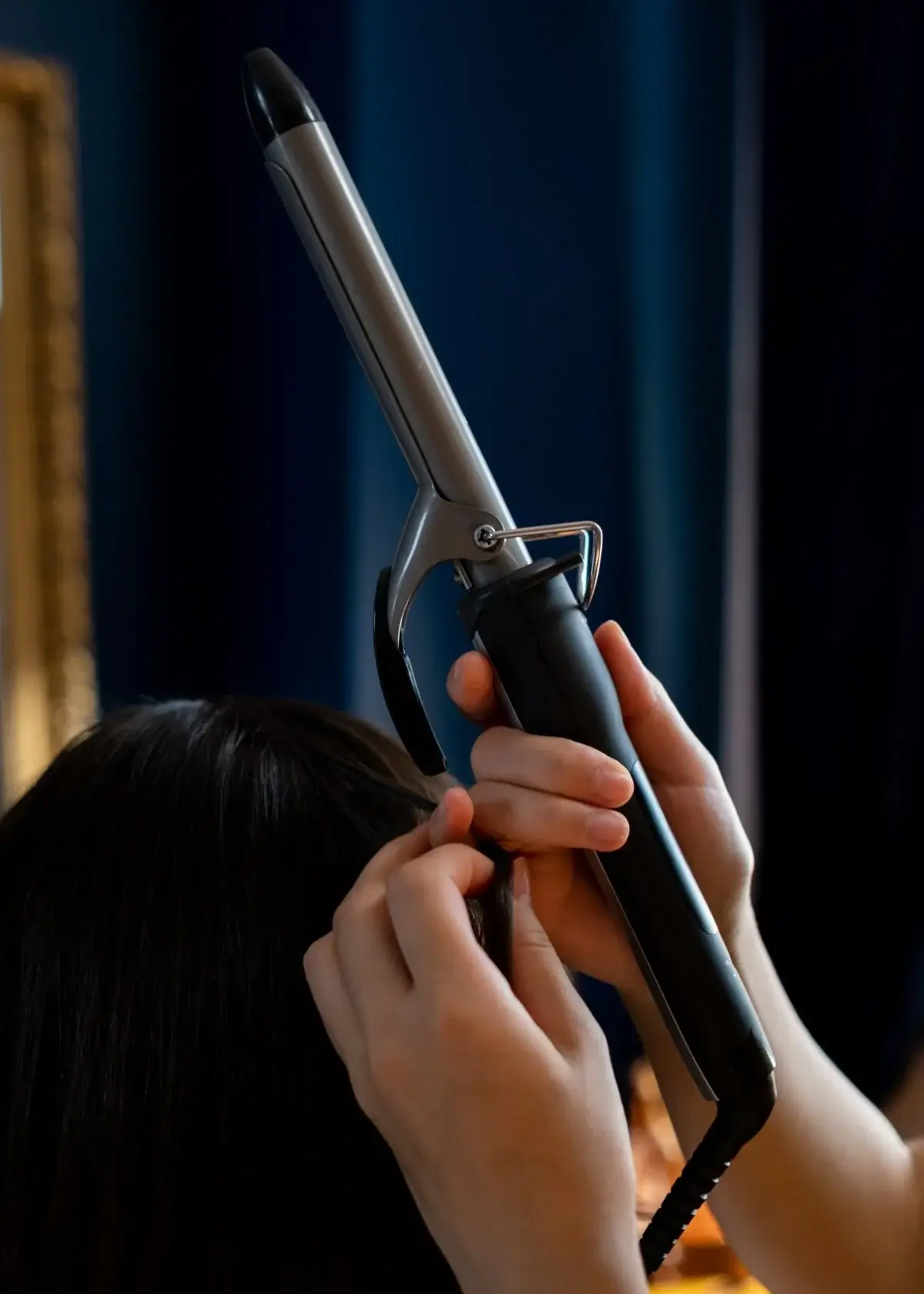 How can I add volume to my hair using a curling iron?